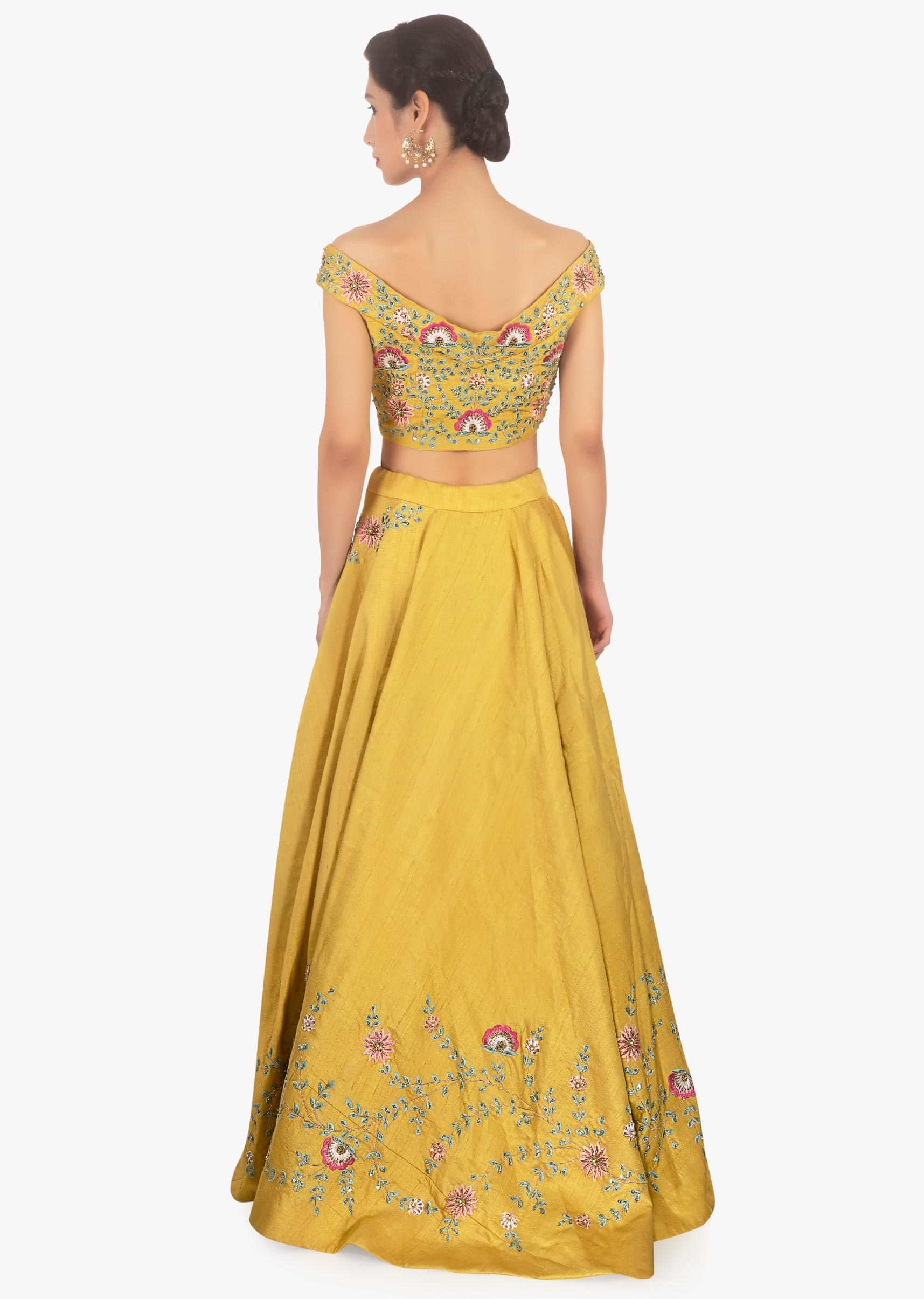 Mustard raw silk lehenga and blouse paired with pink net dupatta 