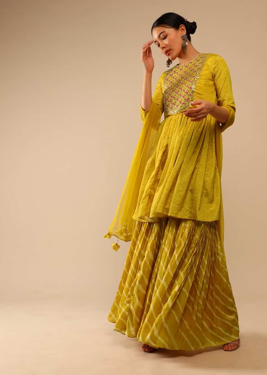 Mustard Sharara Suit In Crepe With Bandhani And Lehariya Print Paired With Resham And Mirror Embroidered Peplum Kurti  