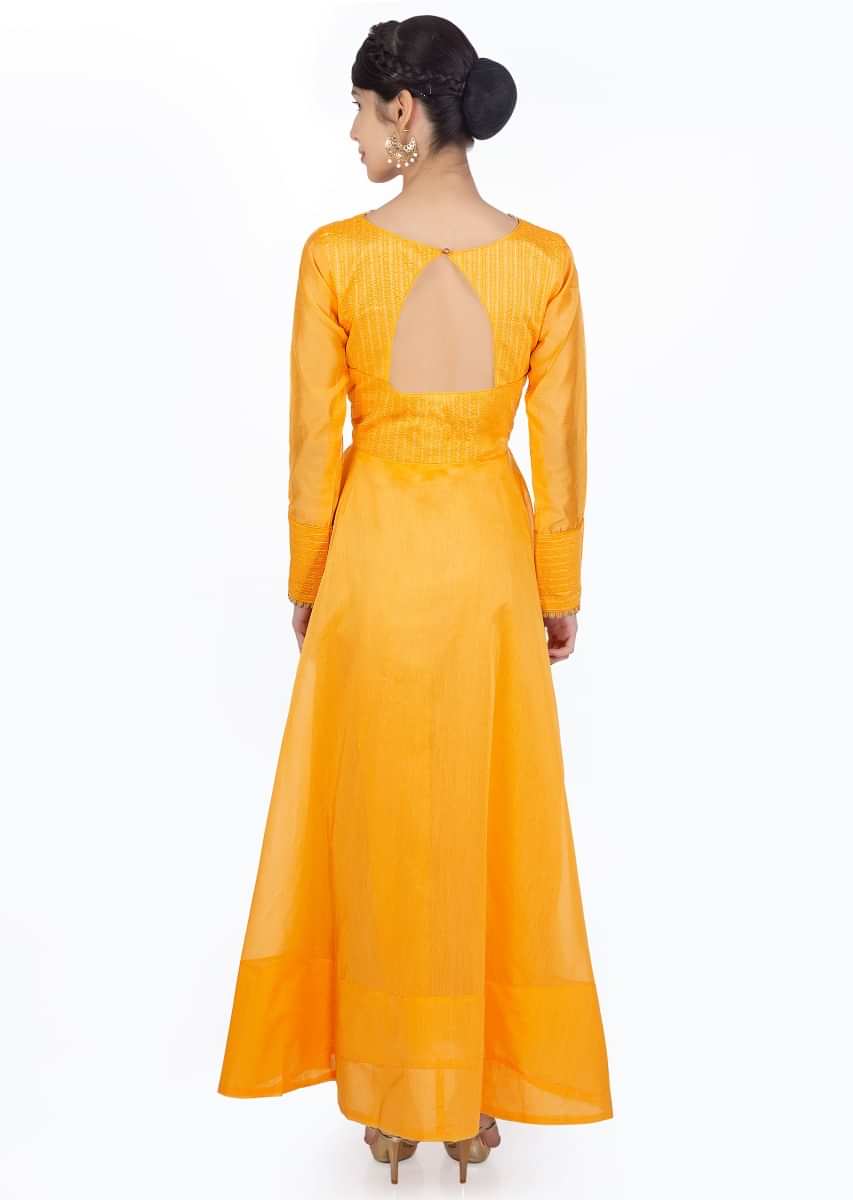 Mustard silk anarkali dress paired with  coral silk weaved dupatta with brocade border 
