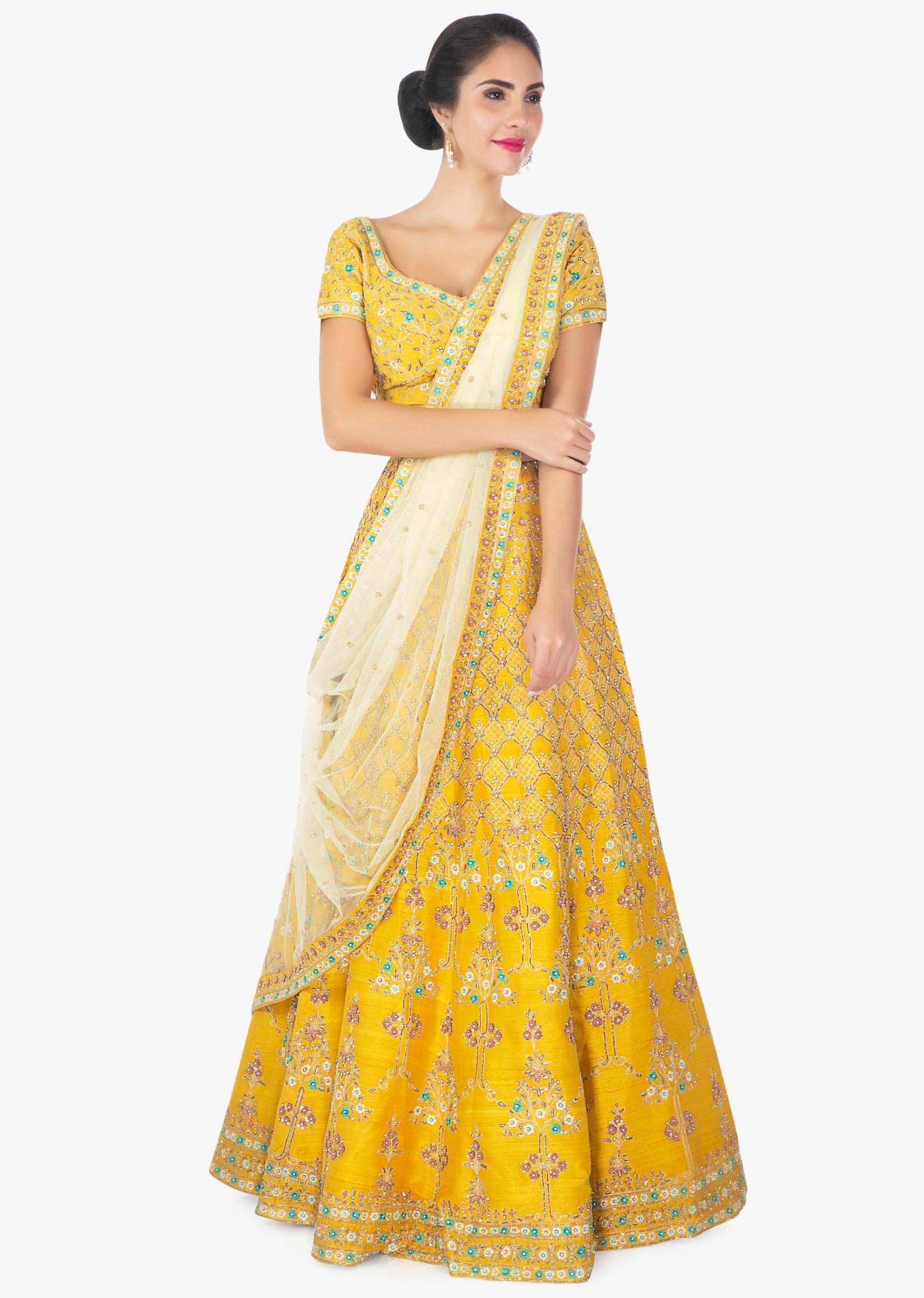 Mustard yellow raw silk lehenga blouse paired with a contrasting net dupatta