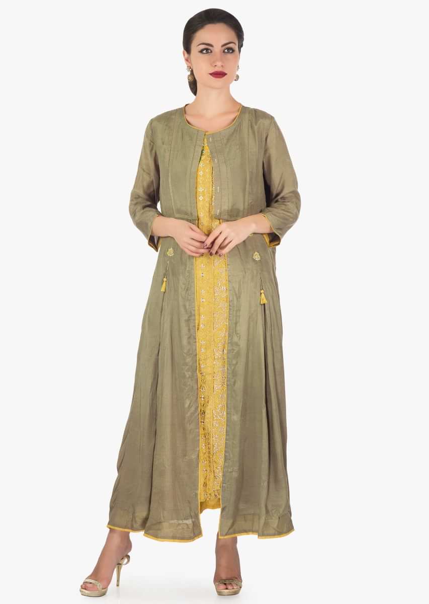 Mustard dress featuring in cotton with resham and zari embroidery with attach jacket only on Kalki