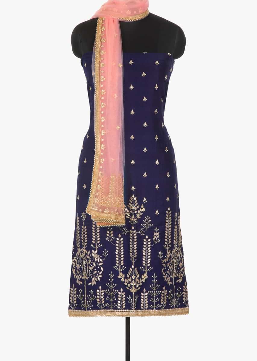 Navy blue unstitched suit featured in silk intricated with gotta patch and moti work only on Kalki