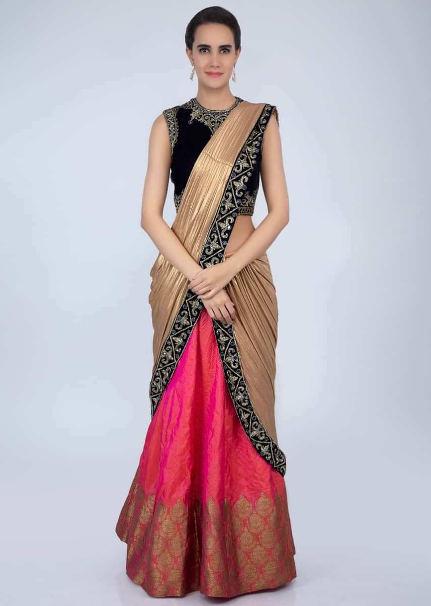 Navy blue velvet blouse matched with coral pink lehenga with attached draped dupatta only on Kalki