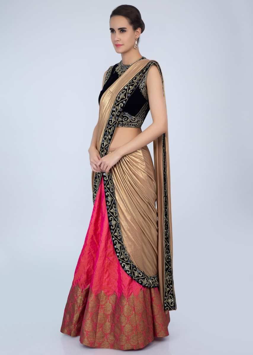 Navy blue velvet blouse matched with coral pink lehenga with attached draped dupatta only on Kalki