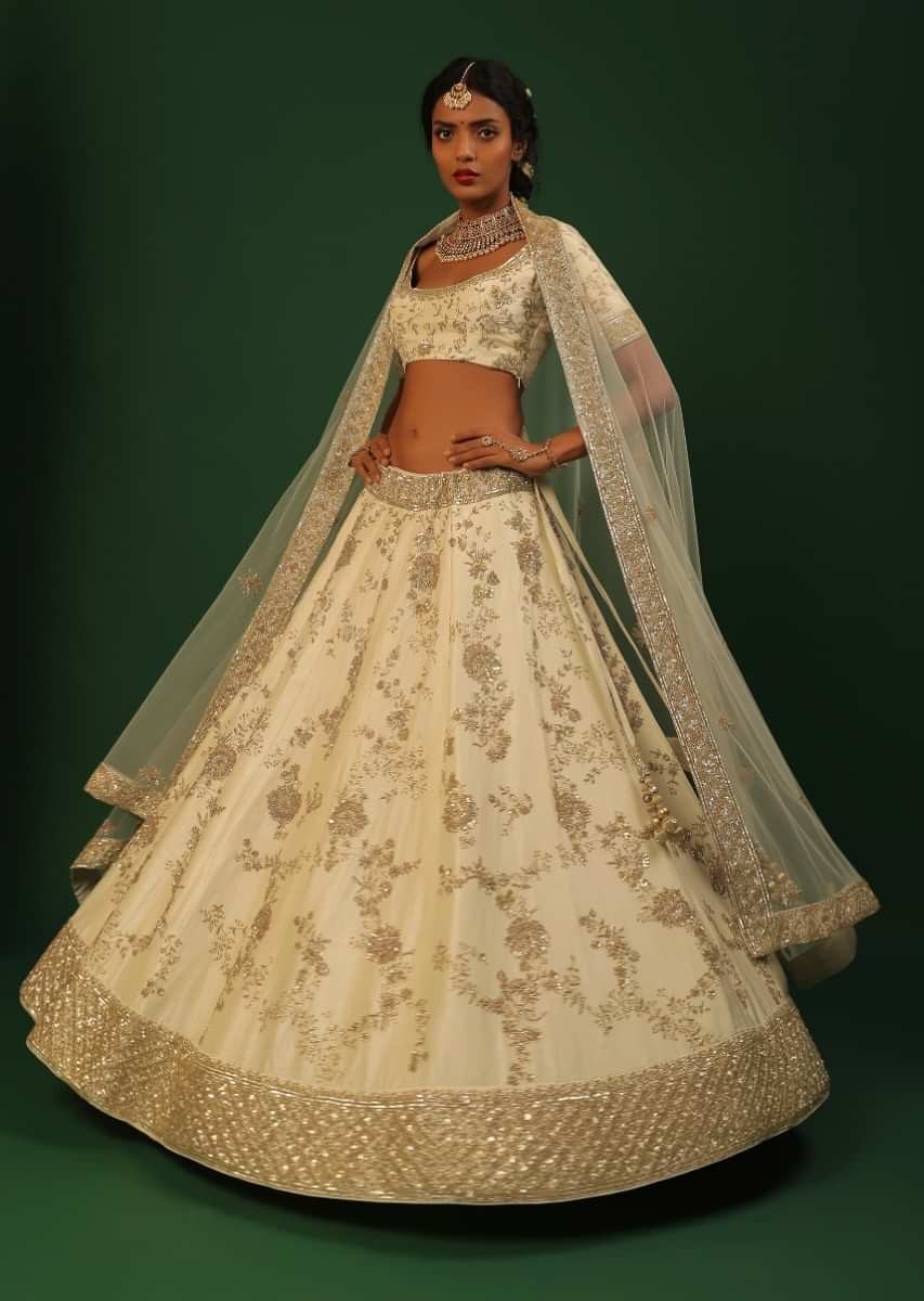 Off White Lehenga Choli In Raw Silk With Golden Cut Dana And Sequins Embroidered Floral Kalis And Geometric Border 