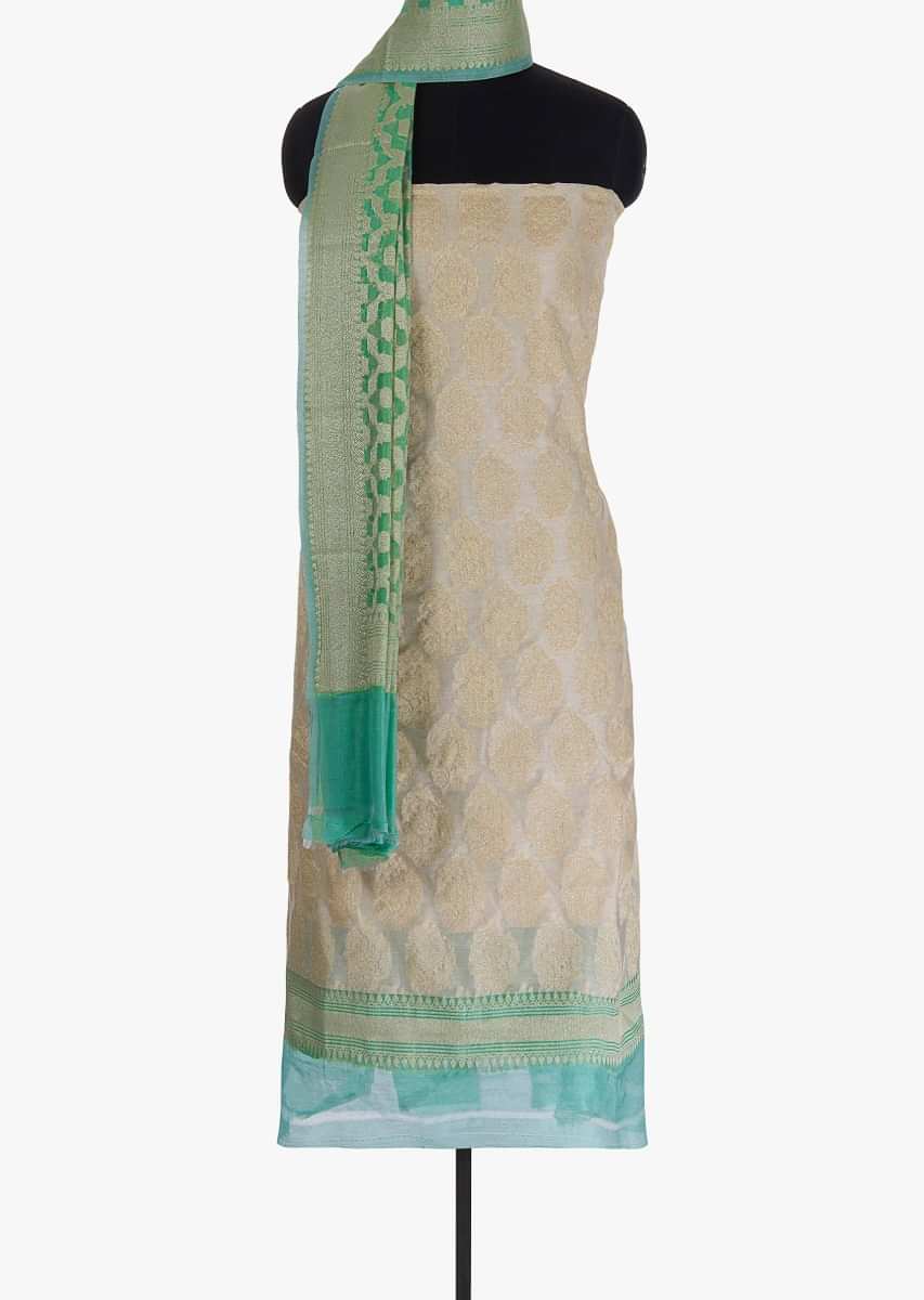 Off white unstitched silk suit in weaved butti 