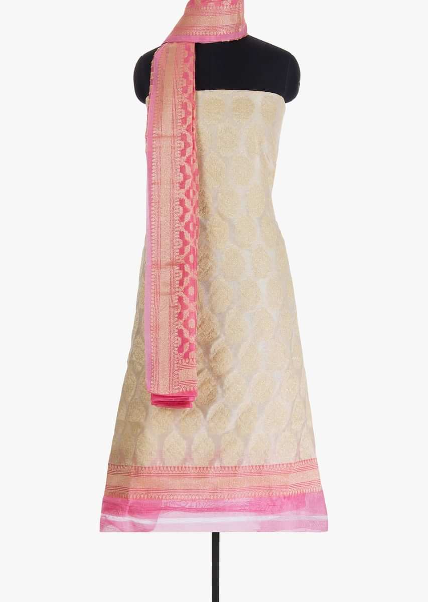 Off white unstitched silk suit in weaved butti and border
