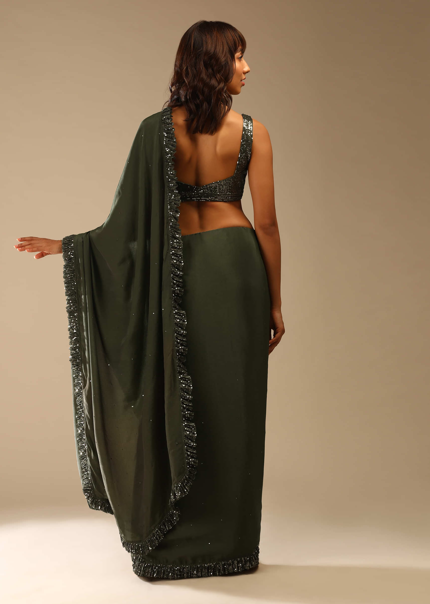 Olive Green Saree In Crepe With Sequins Ruffle On The Border, Sequins Blouse With Front Cut Out And Embellished Belt  