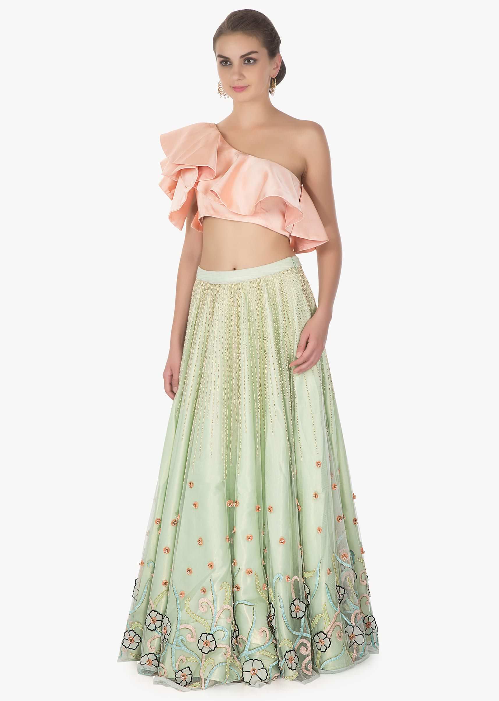 One shoulder ruffled peach crop top paired with Pista green net skirt in 3 D flowers
