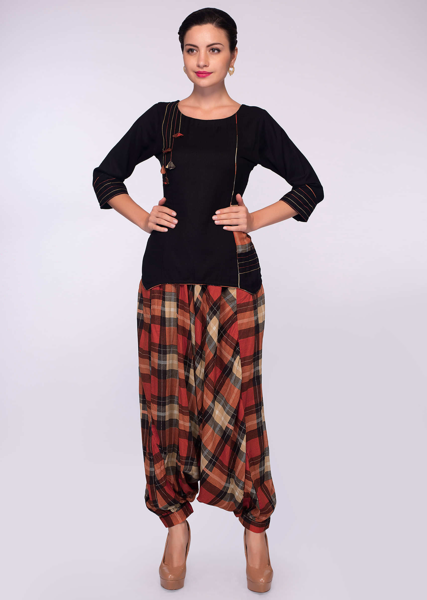 Orange cotton checks dhoti pants paired with black cotton top in running stitches 