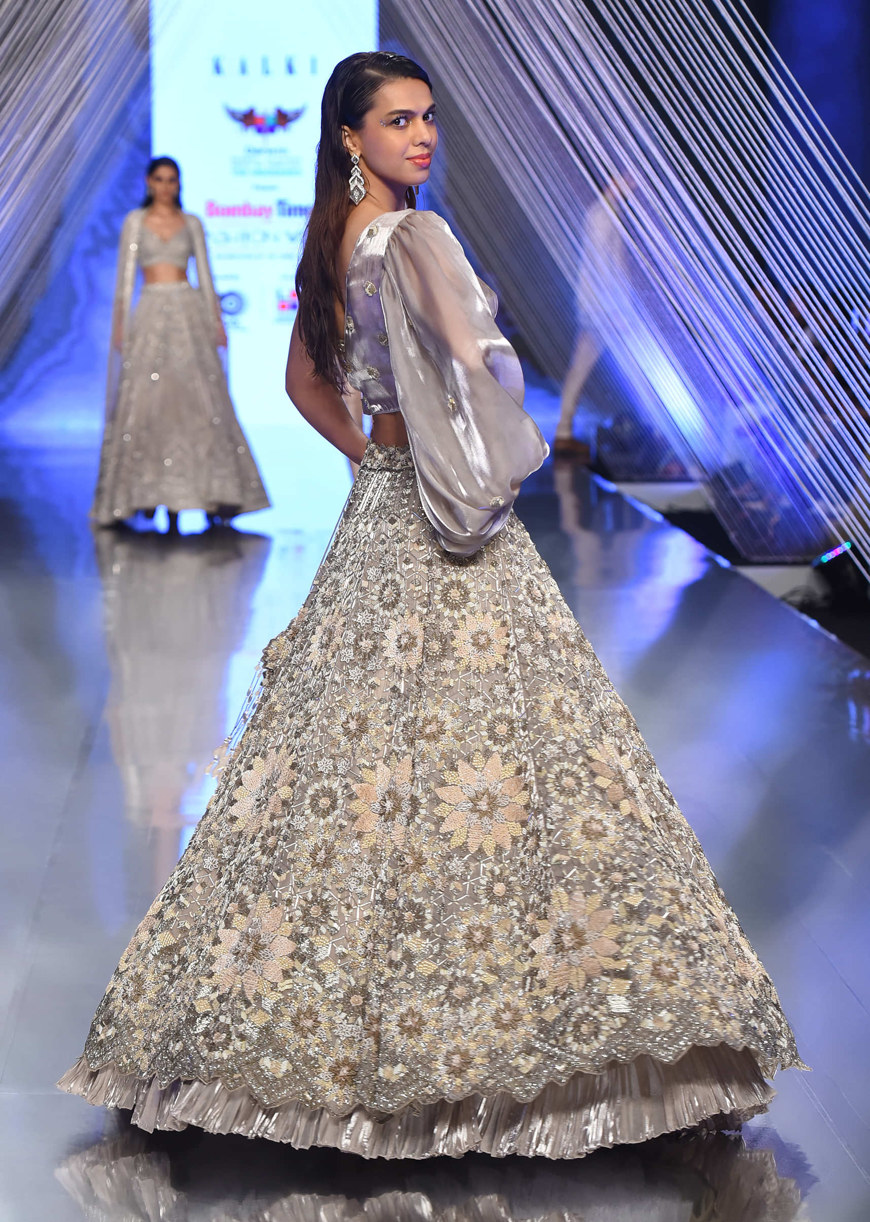 Oyster Lehenga And A Crop Top With One Sided Balloon Sleeves Tie Up Top And Cut Dana Motifs Embroidery
