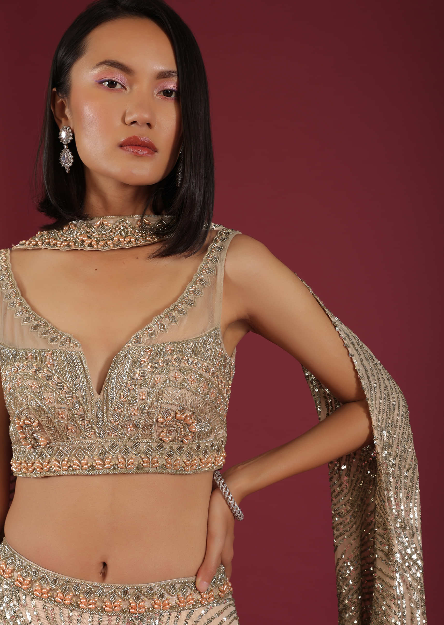 Oyster Lehenga And A Crop Top In 3D Petal Motifs Embroidery, Crafted In Net With A Side Zip Closure