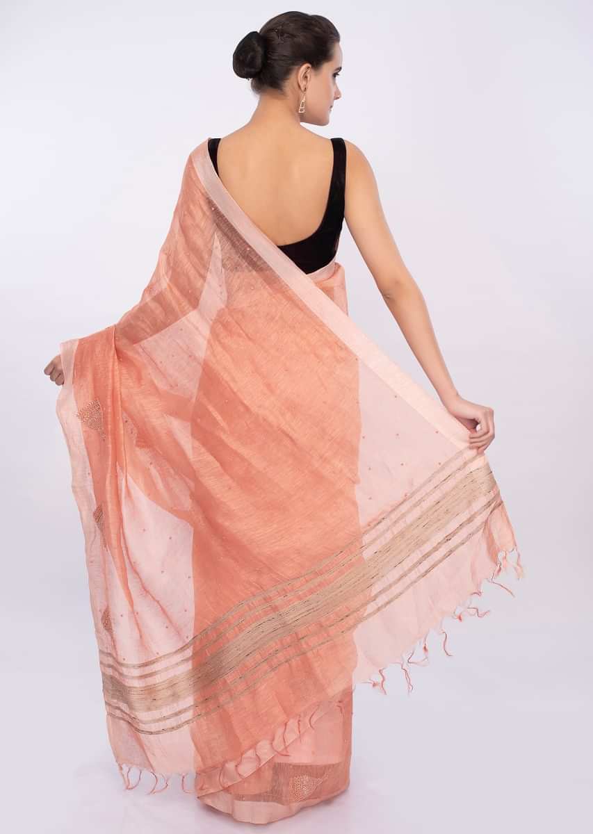 Pale orange linen saree with self moti embroidery and butti only on Kalki