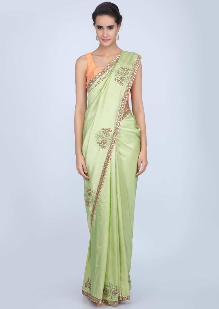 Parrot green dupion silk saree with embroidered butti and border in human and elephant motif only on Kalki