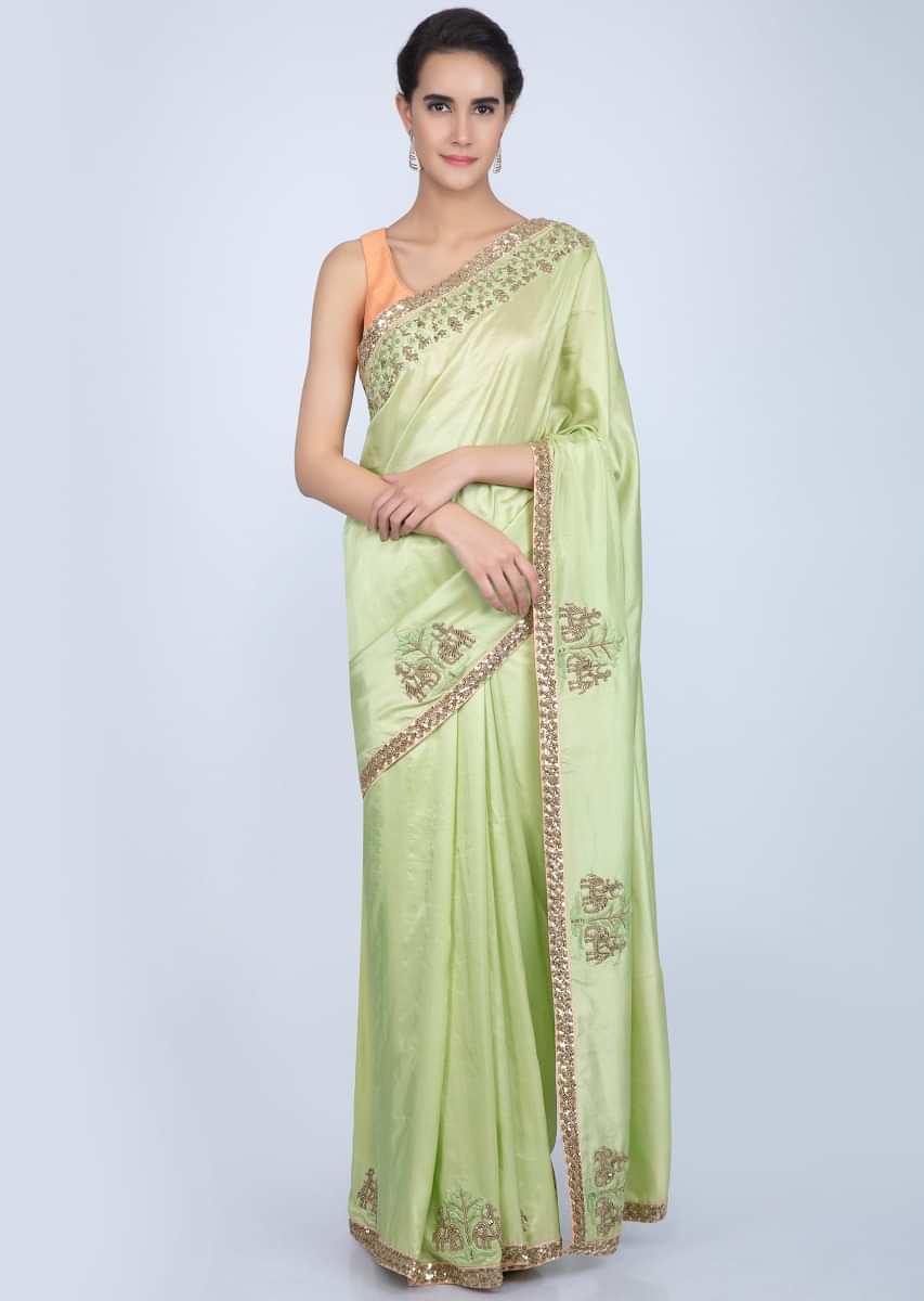 Parrot green dupion silk saree with embroidered butti and border in human and elephant motif only on Kalki