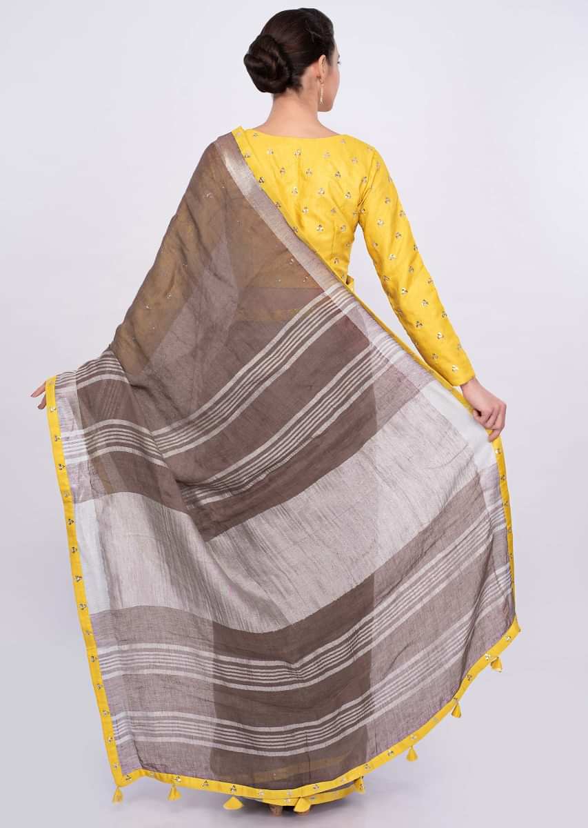 Pastel brown jute cotton saree with yellow border only on Kalki