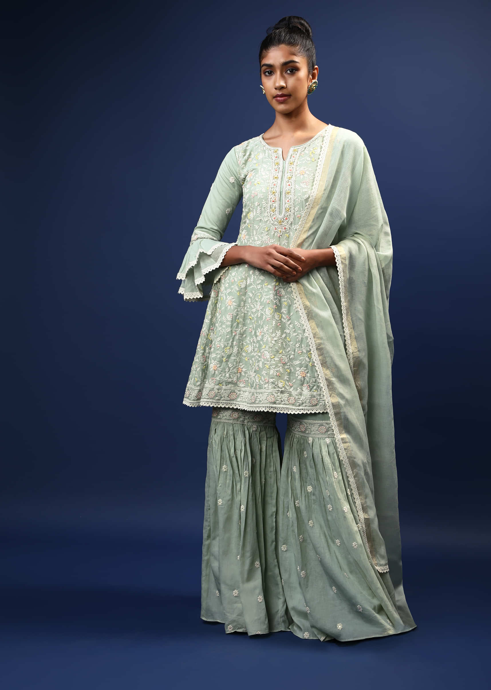 Pastel Green Sharara Peplum Suit In Cotton With Pastel And White Thread Embroidered Floral Motifs And Ruffle Sleeves  