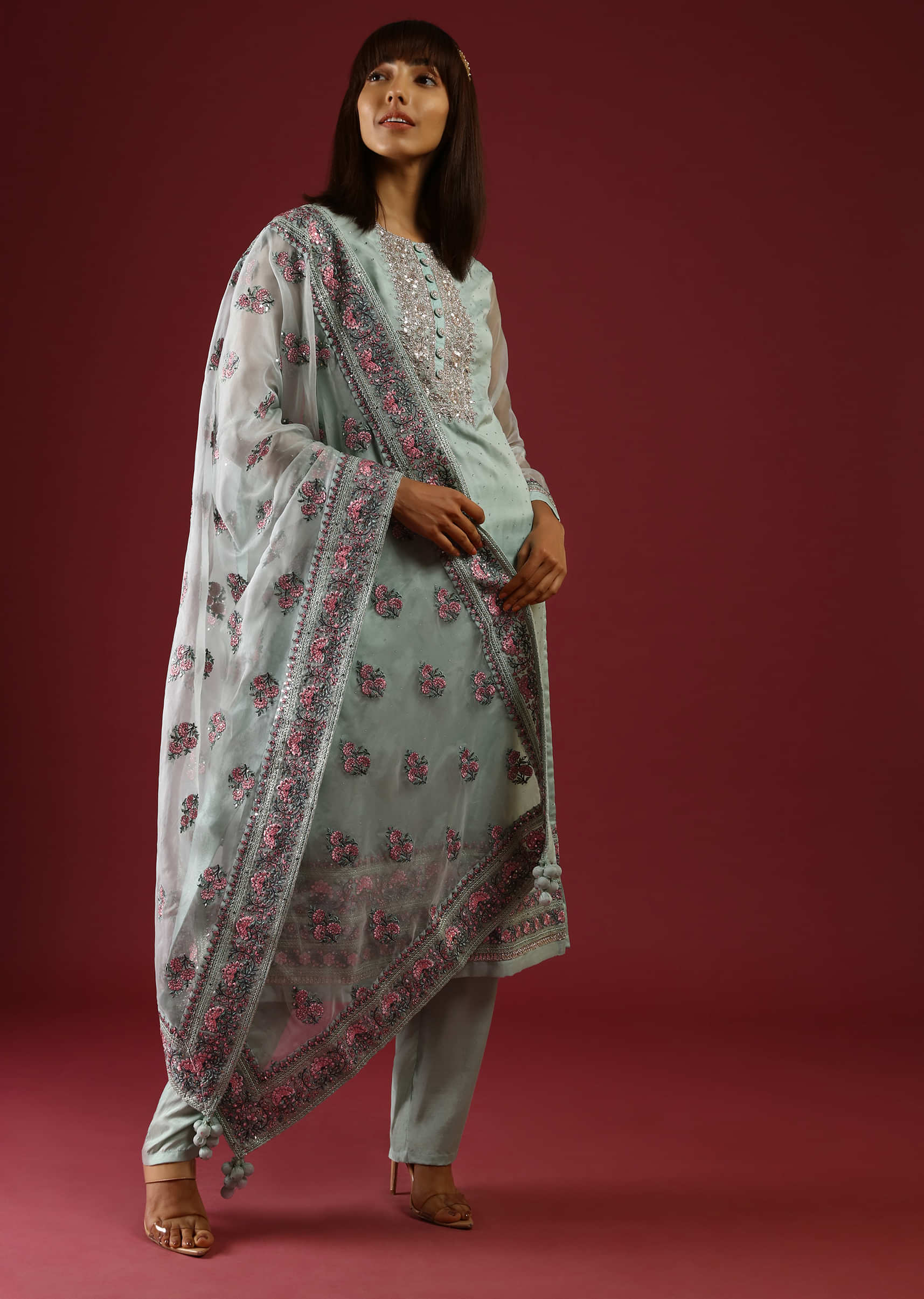 Pastel Green Straight Cut Suit With Multi Colored Thread Embroidered Floral Motifs On The Border And Buttis On The Organza Dupatta  