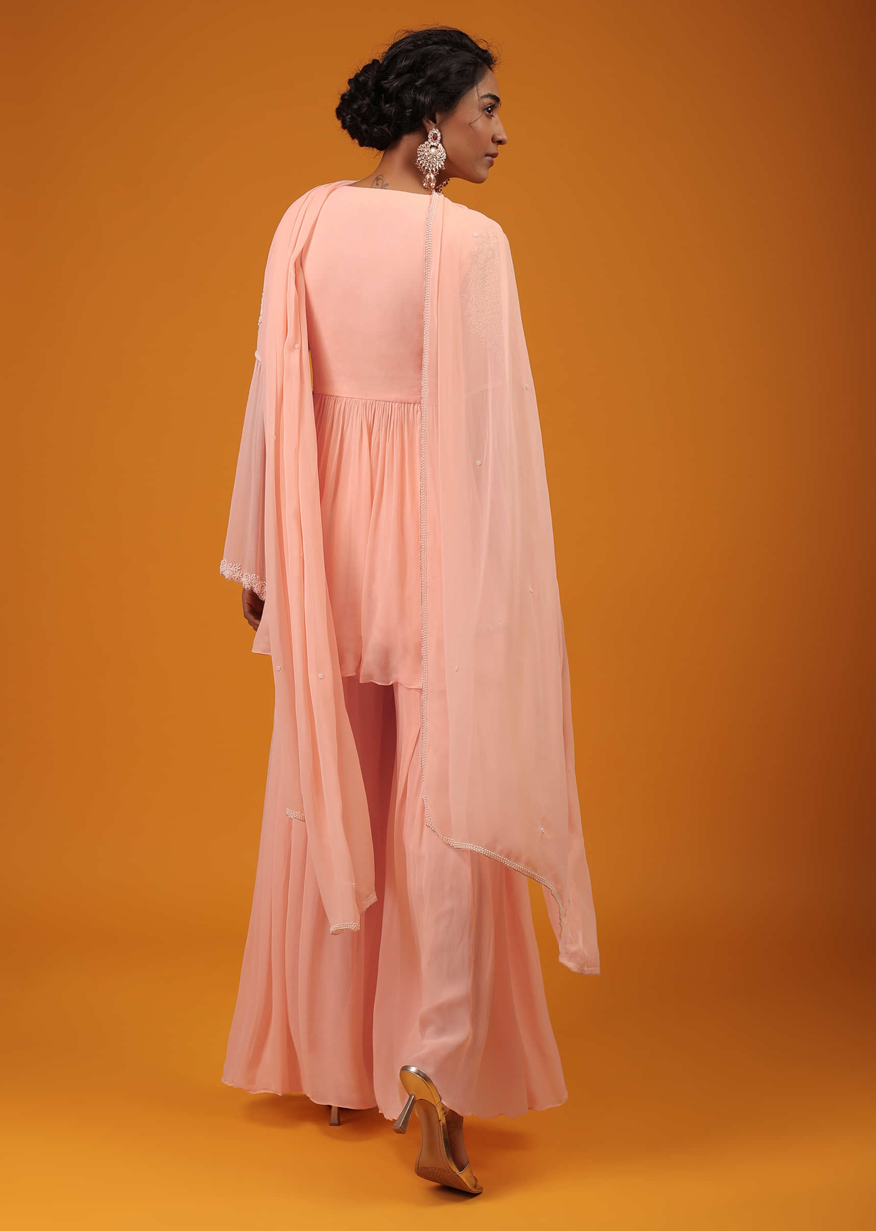 Pastel Pink Peplum Palazzo Suit In Georgette With Intricate Moti Work And Bell Sleeves