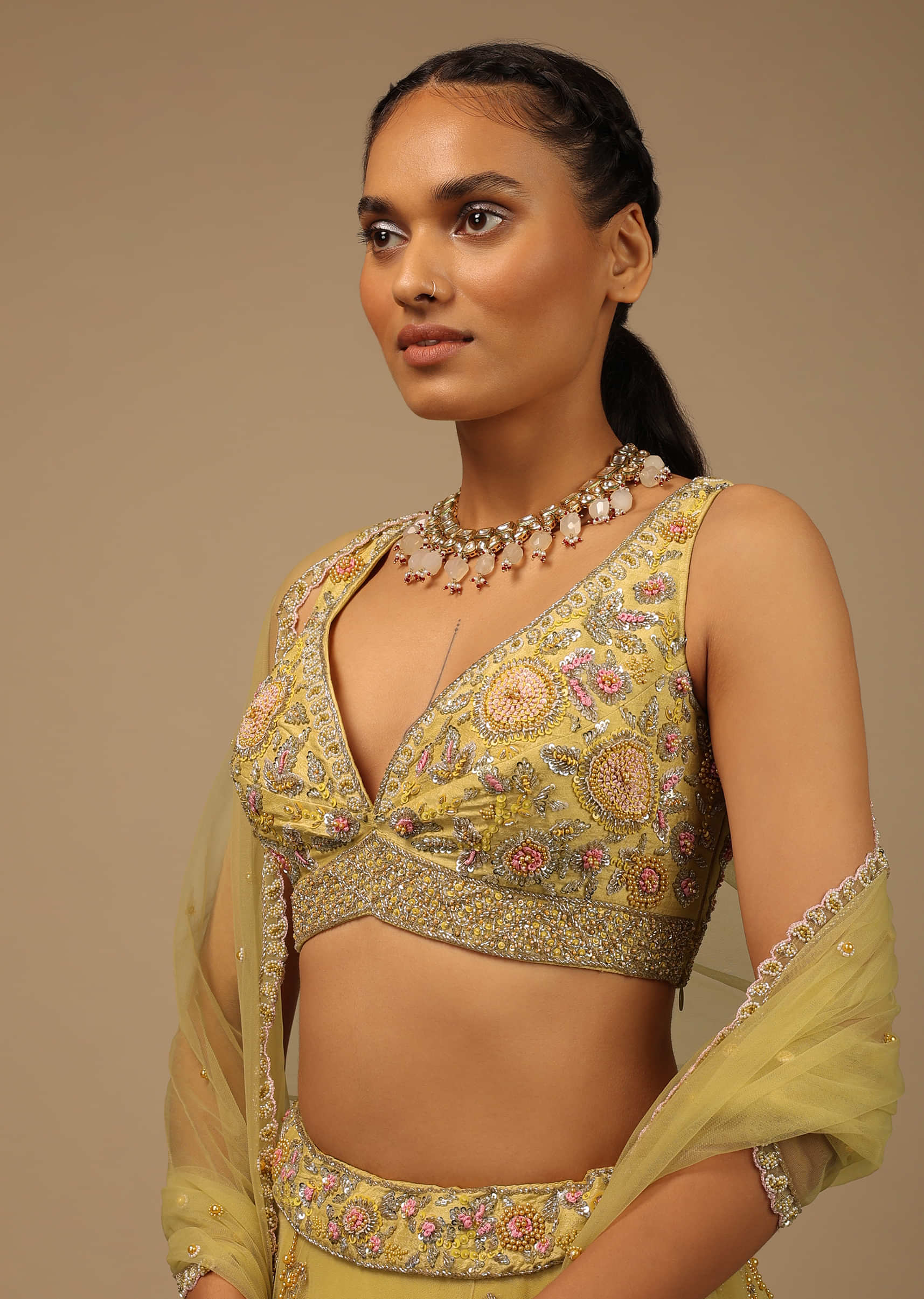 Pastel Yellow Lehenga Choli In Net With Multi Colored Beads And Sequins Embroidered Floral Motifs