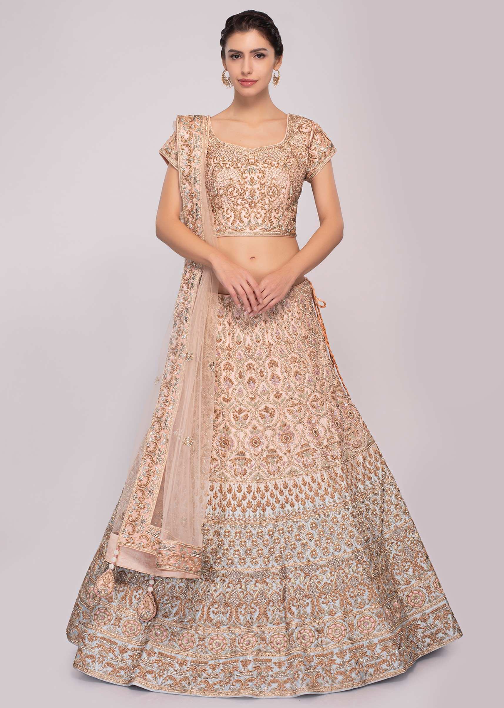Peach and blue shaded raw silk lehenga paired with matching embroidered blouse and net dupatta