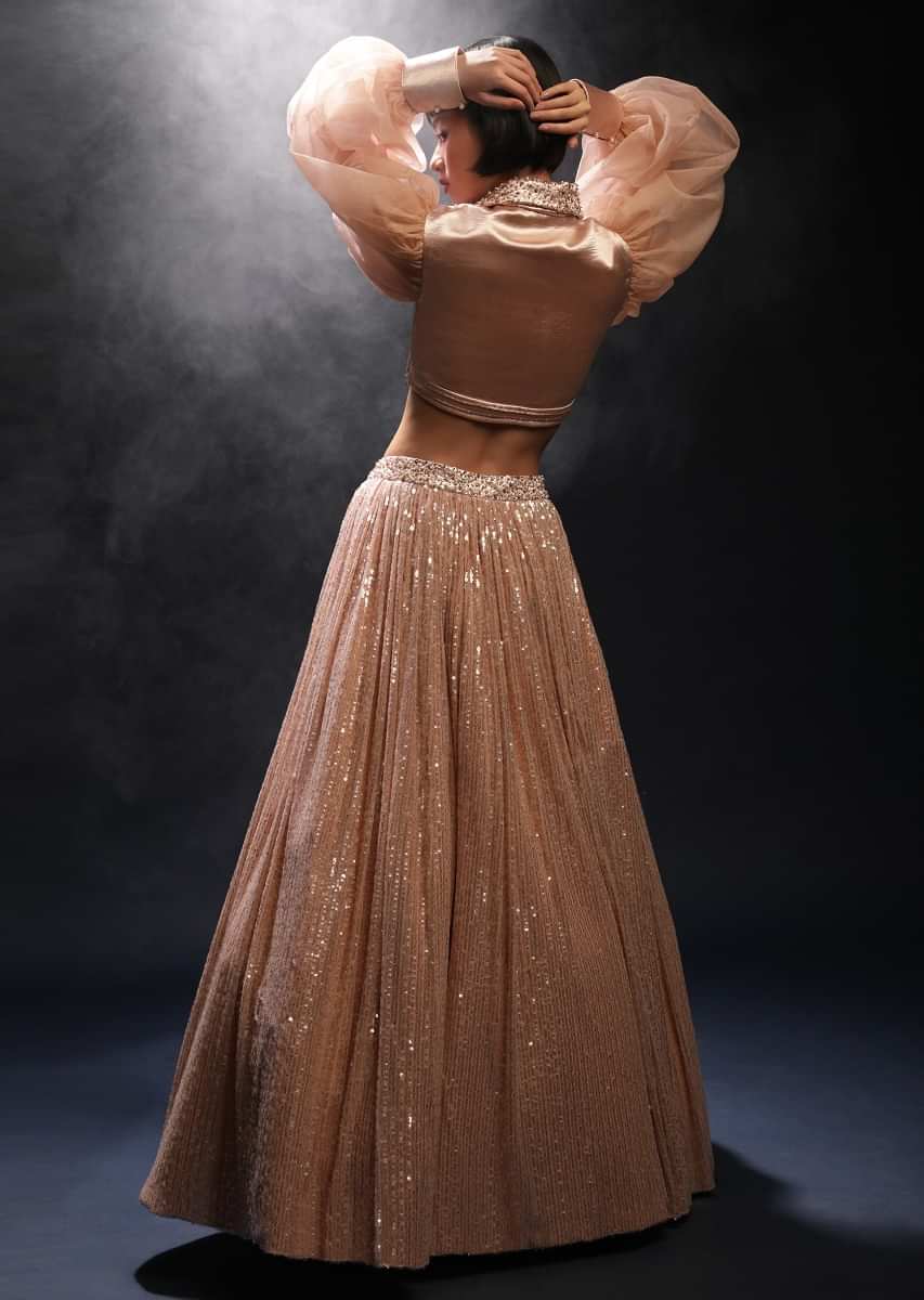Peach Champagne Lehenga Embellished In Sequins And Velvet Crop Top Designed With Balloon Sleeves And Collar Neckline
