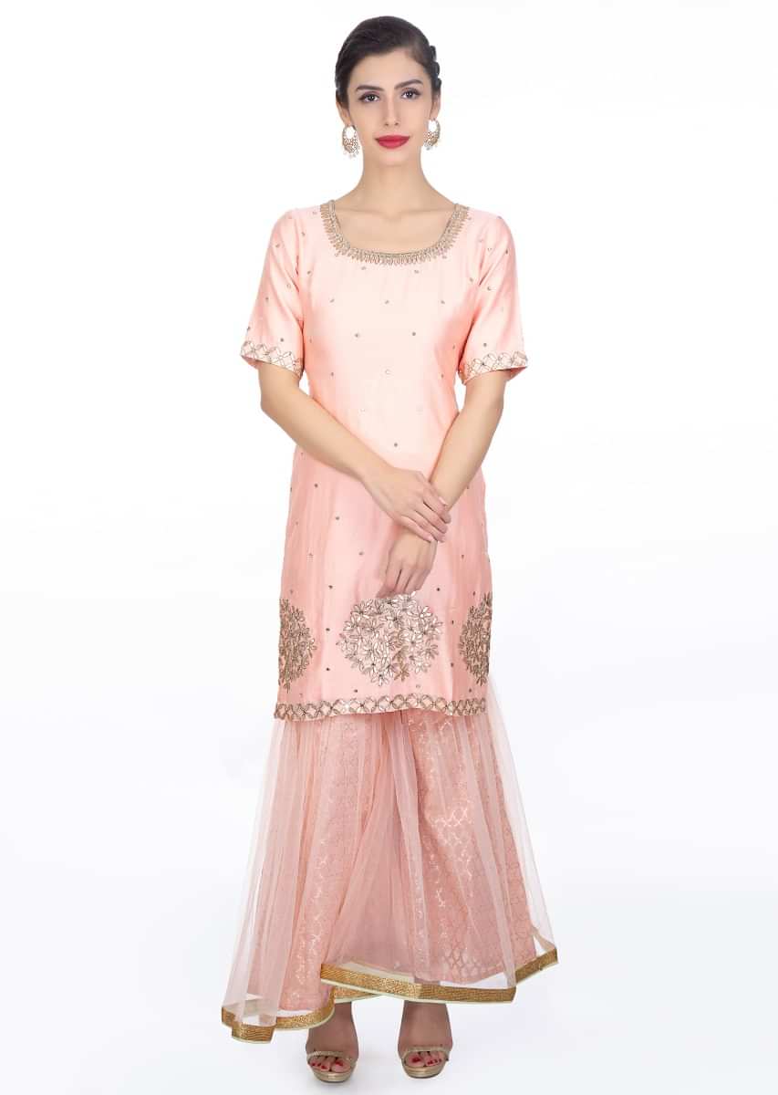 Peach embroidered silk suit paired with brocade lehenga in net lining and a contrasting  net dupattaonly 