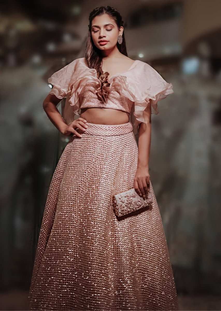 Peach fancy fabric ruffled blouse with matching lehenga with in glitter only on Kalki