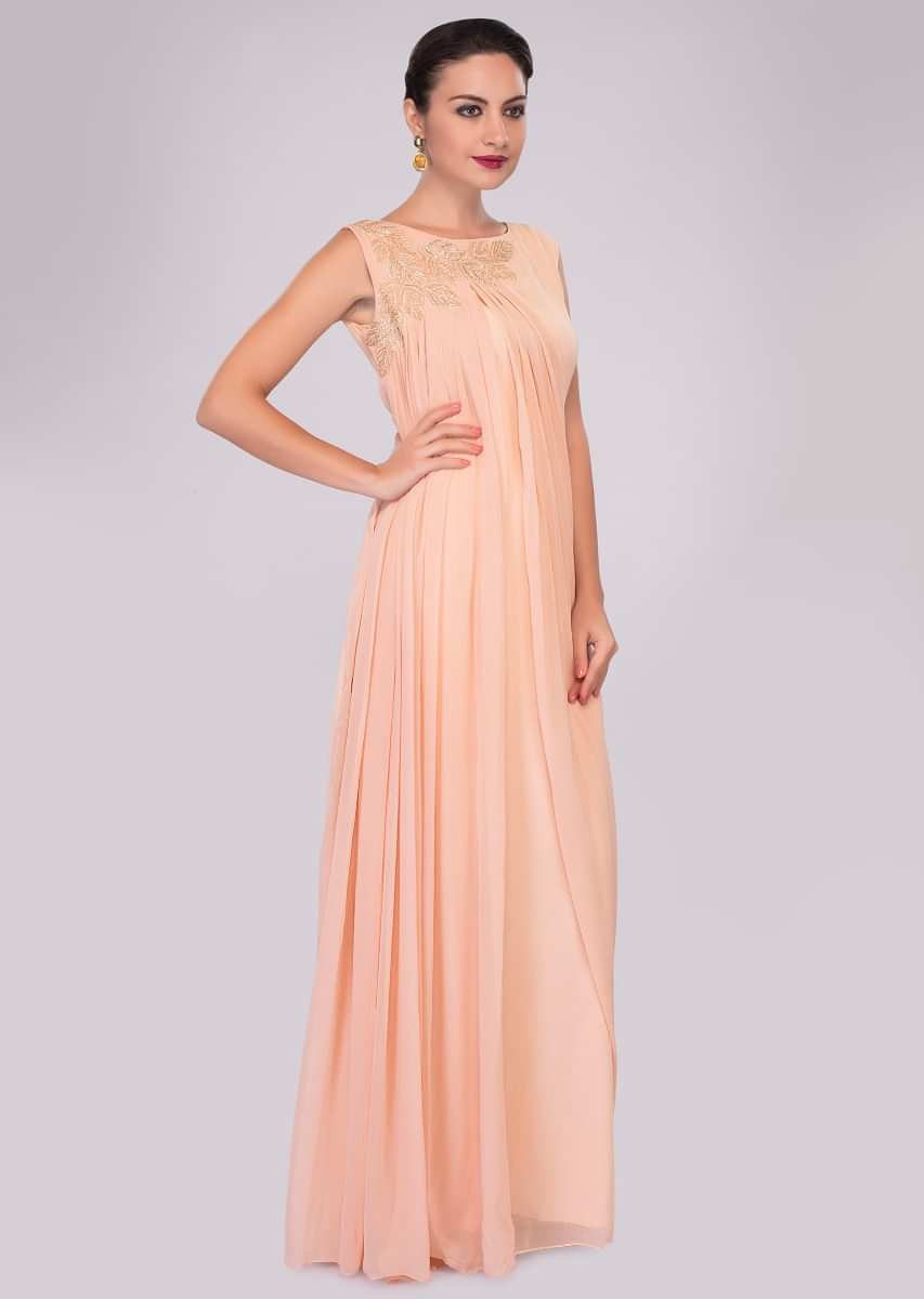 Peach georgette tunic dress enhanced with pleats and side cowl drape 