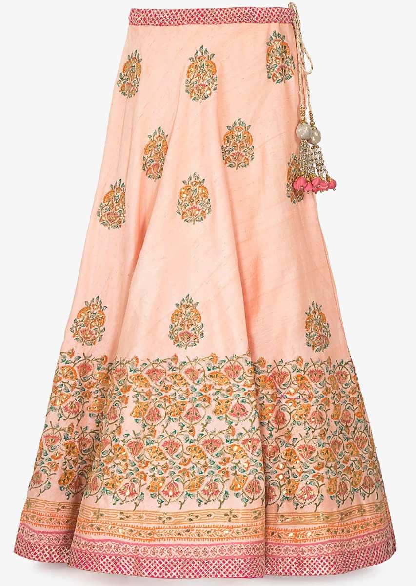 Peach raw silk lehenga with zari gotta patch work over the digital floral print design on the lehenga and on blouse