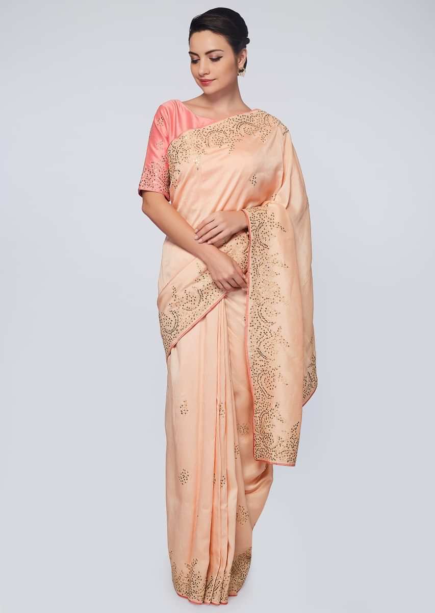 Peach raw silk saree in zari and sequins embroidered butti and border 