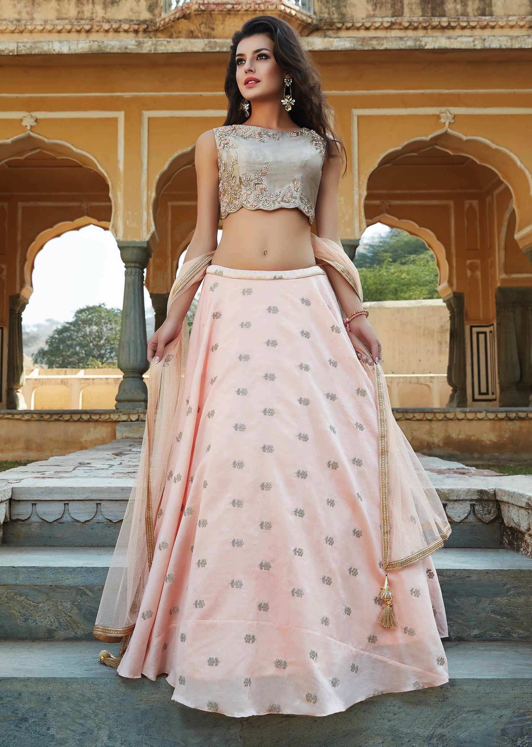 Peach lehenga in raw silk with contrast blouse in french knot and kundan embroidery only on Kalki