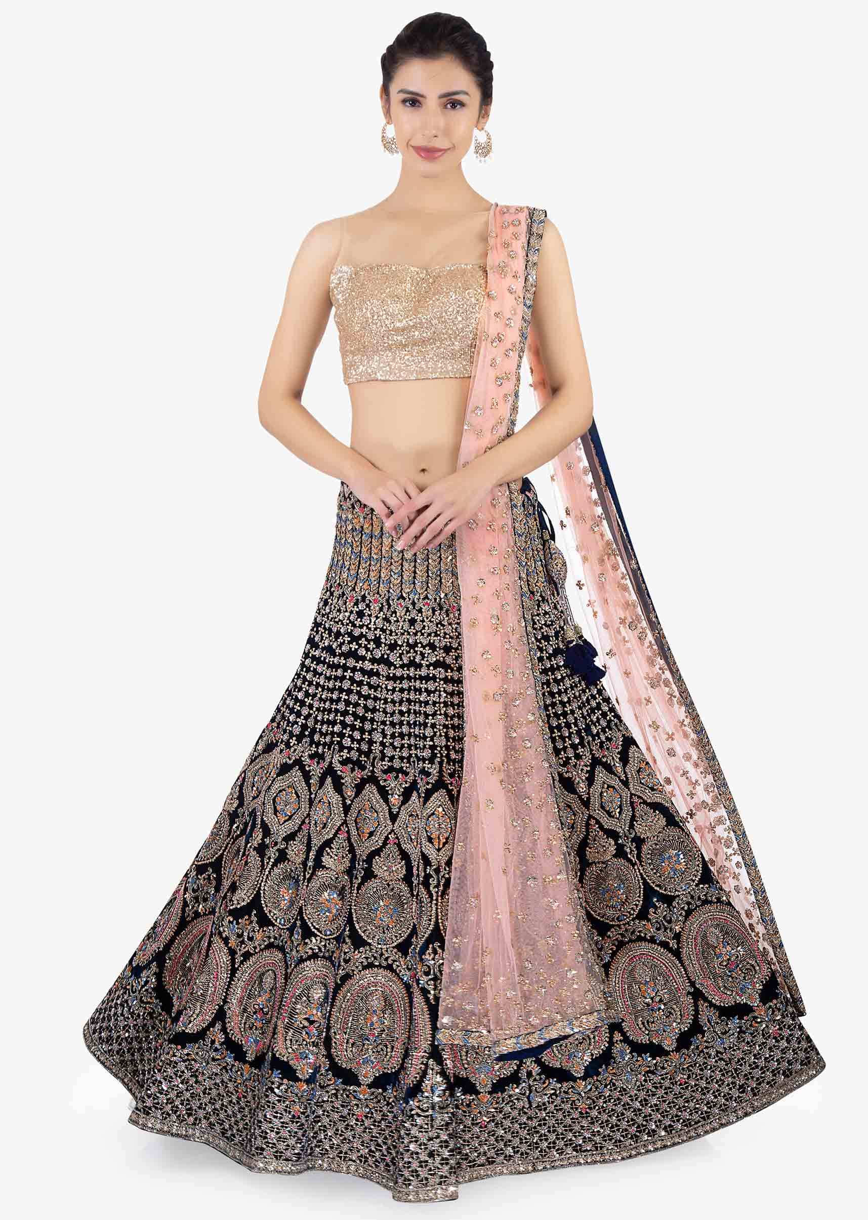 Peacock green  heavily embellished lehenga set paired with a pink net dupatta  