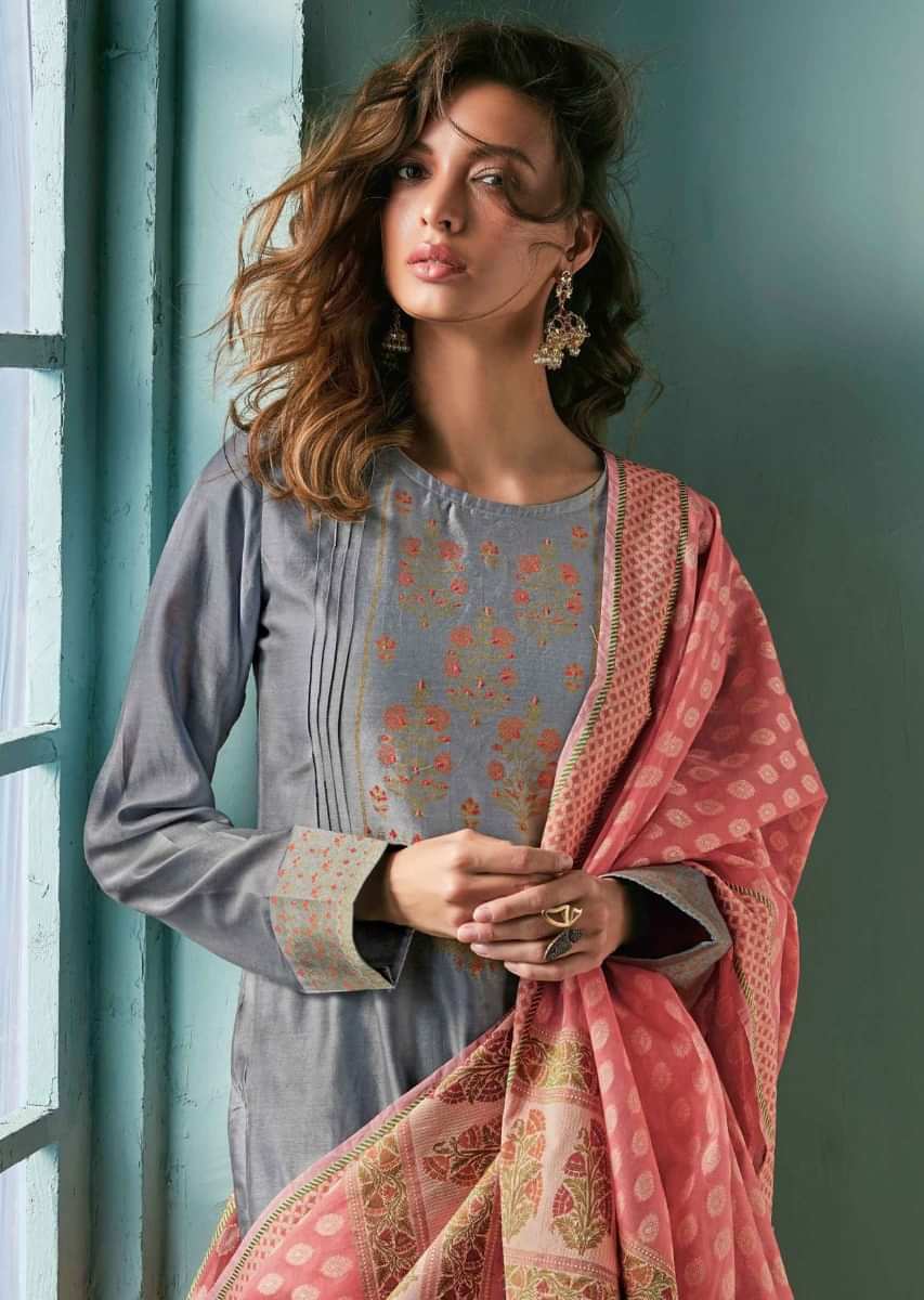 Pewter grey unstitched suit adorn in foil printed placket in floral motif matched with peach dupatta