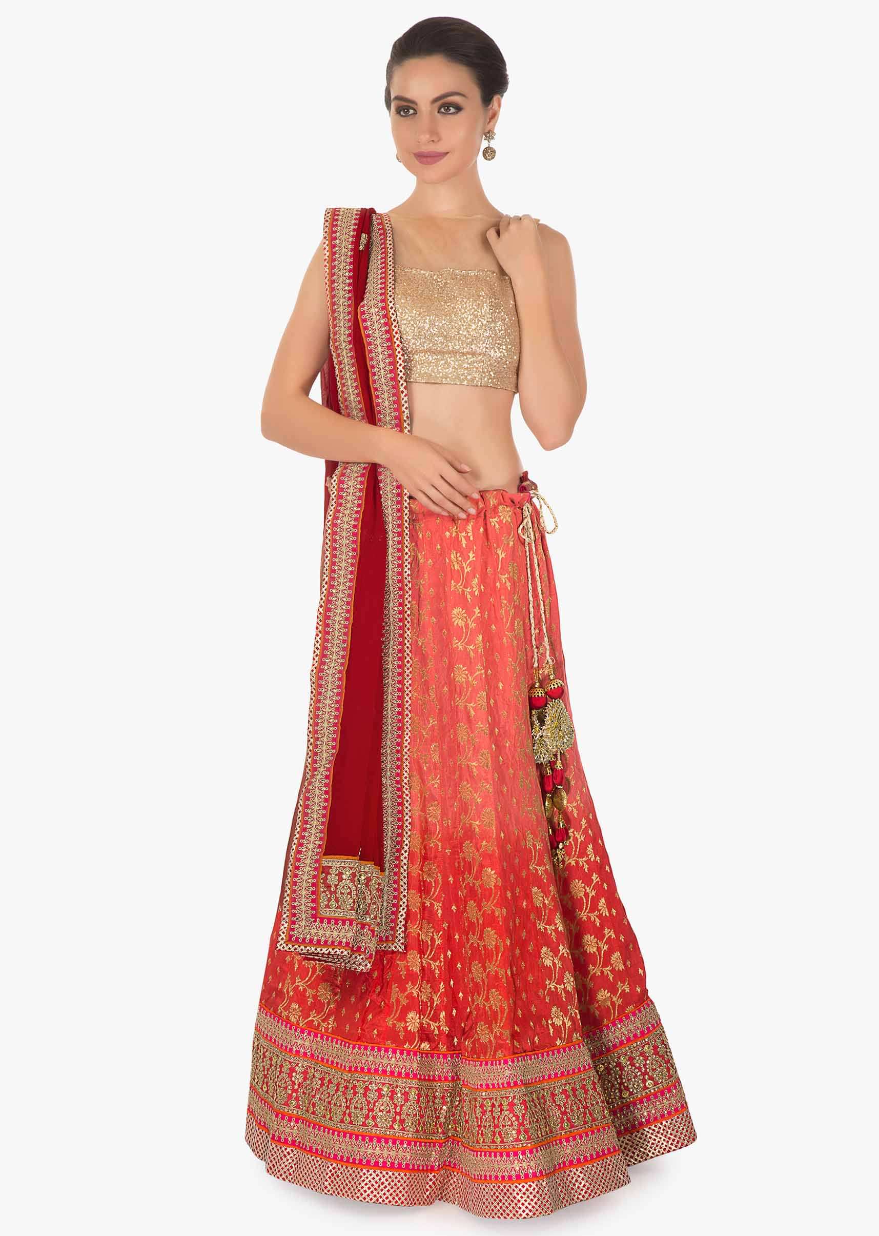Orange and coral shaded lehenga matched with a coral brocade blouse and georgette lace dupatta only on kalki