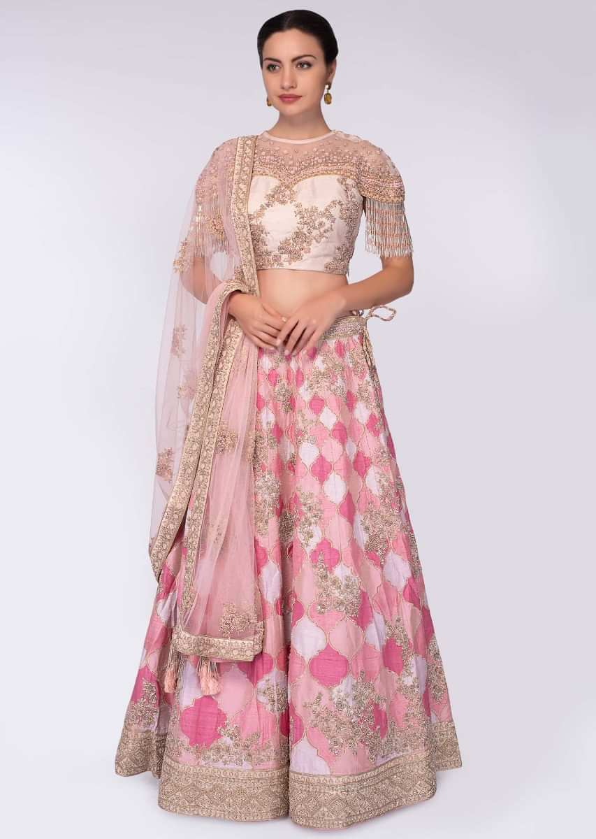 Pink and white shade raw silk lehenga paired with light champagne embroidered net blouse