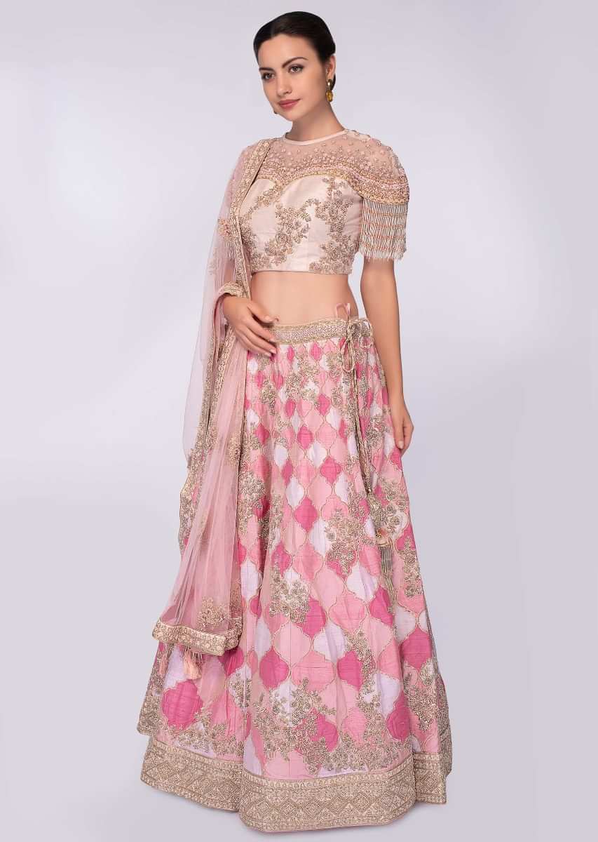 Pink and white shade raw silk lehenga paired with light champagne embroidered net blouse