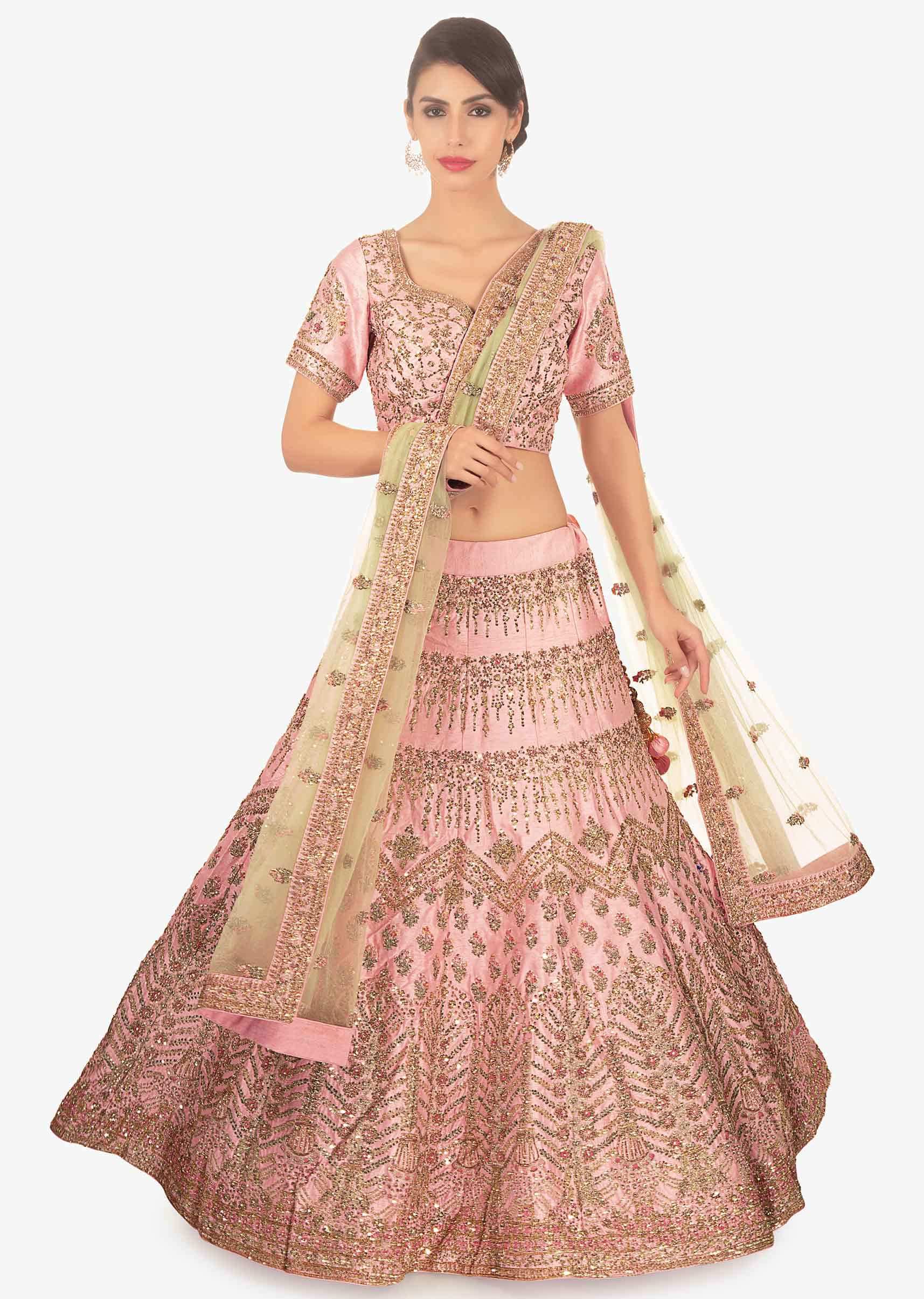 Pink raw silk embellished lehenga set paired with herbal green net dupatta 