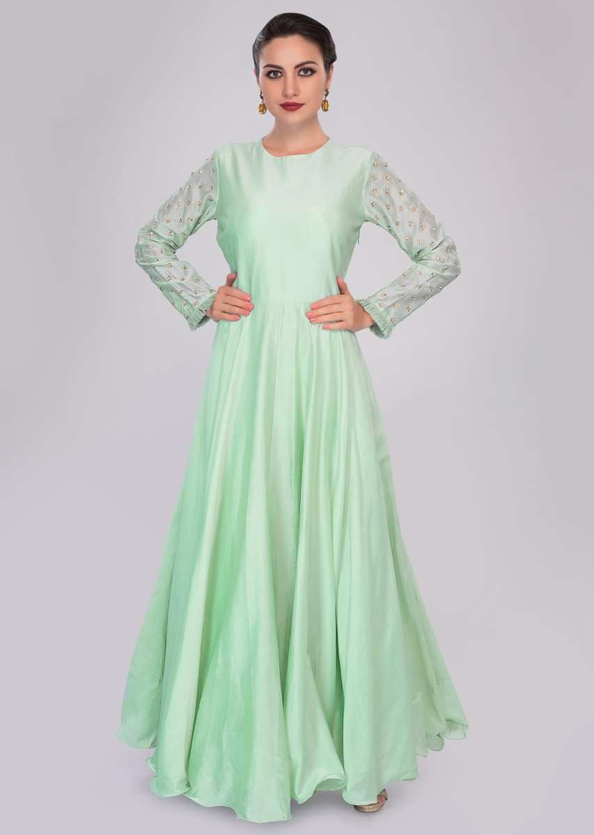 Pista green cotton anarkali dress styled with matching floral embroidered organza jacket