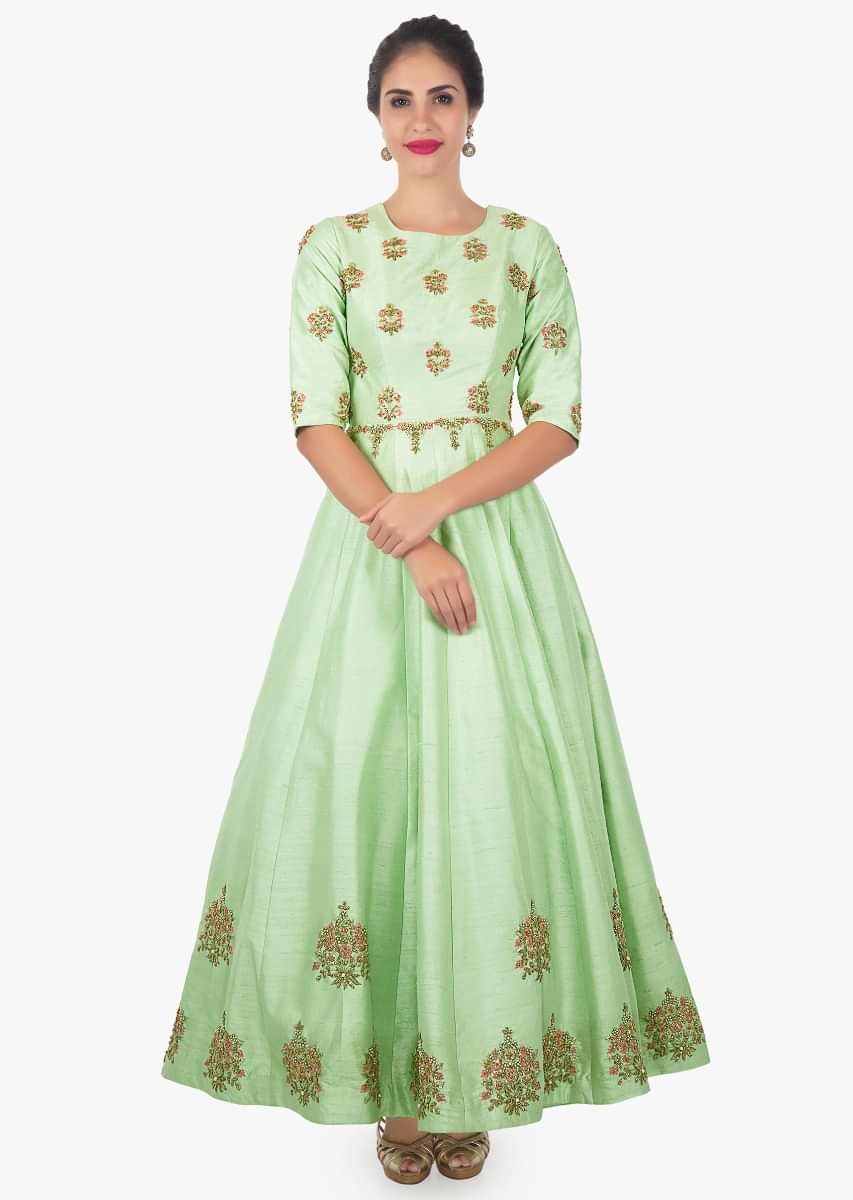 Pista green raw silk anarkali paired with contrasting pink net dupatta only on Kalki
