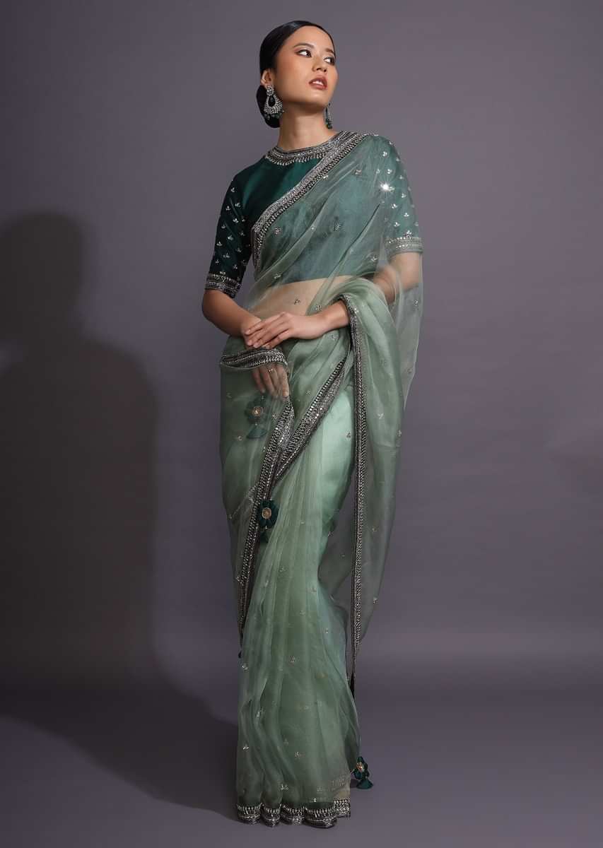 Pista Green Saree In Organza With Mirror Embellished Buttis And Contrasting Dark Green Border  