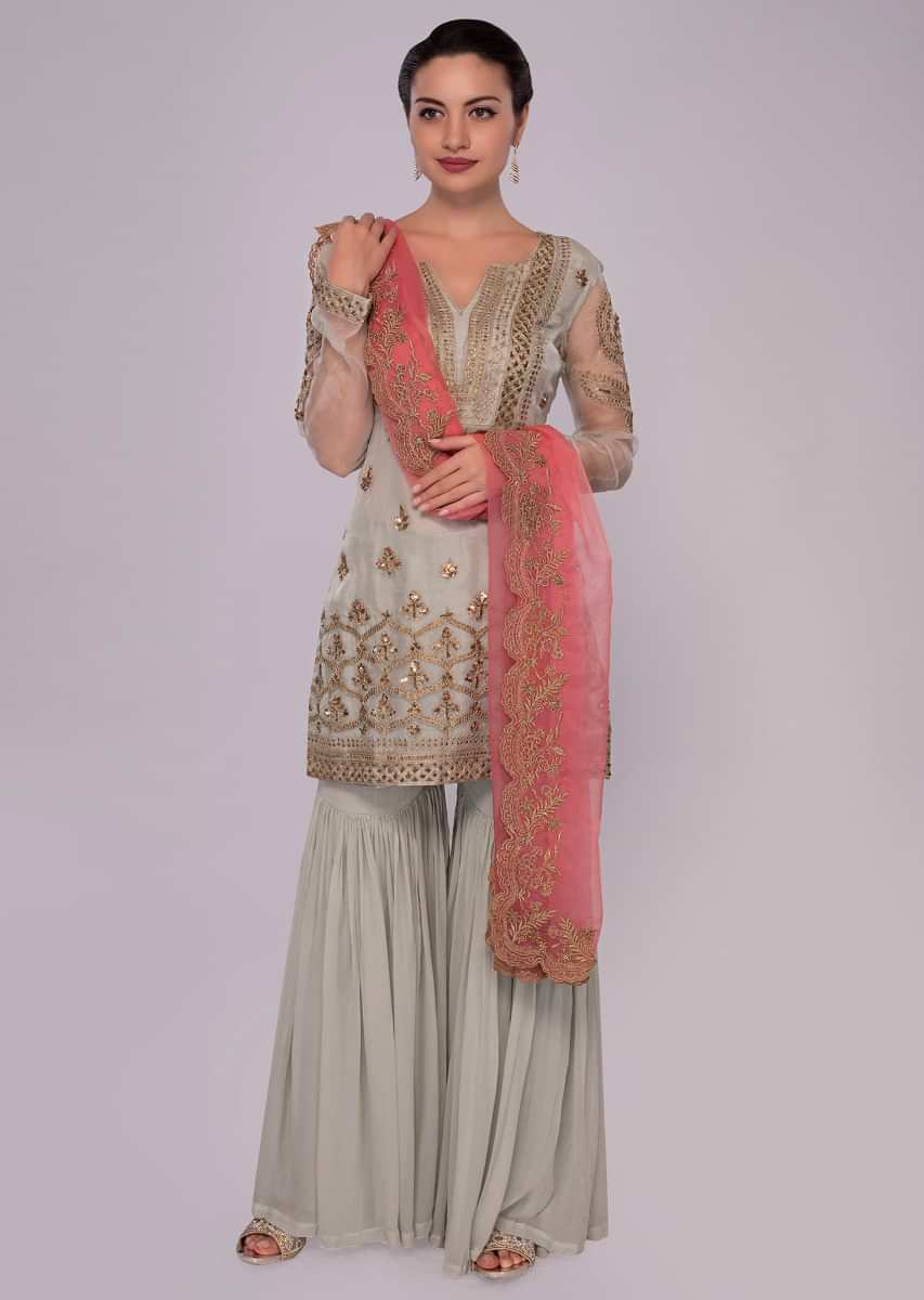 Pista green sharara suit with contrasting peach dupatta