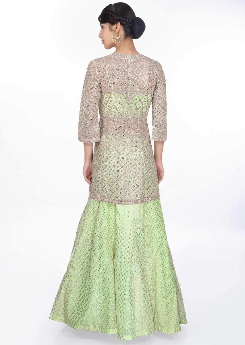 Pista green weaved lehenga paired with a strap crop top along with embroidered net top layer and net dupatta