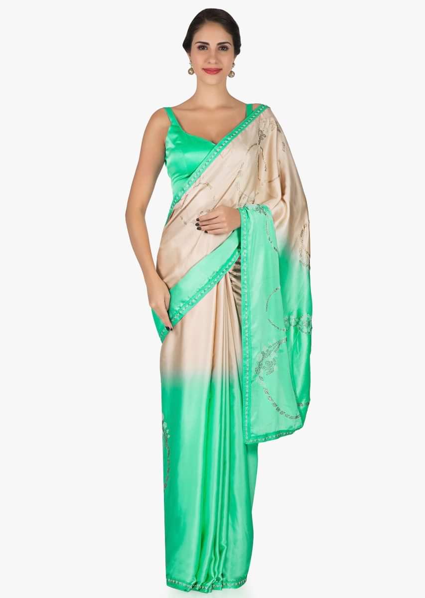 Pista green and cream saree in satin with unstitched blouse crafted in kundan embroidery work only on Kalki