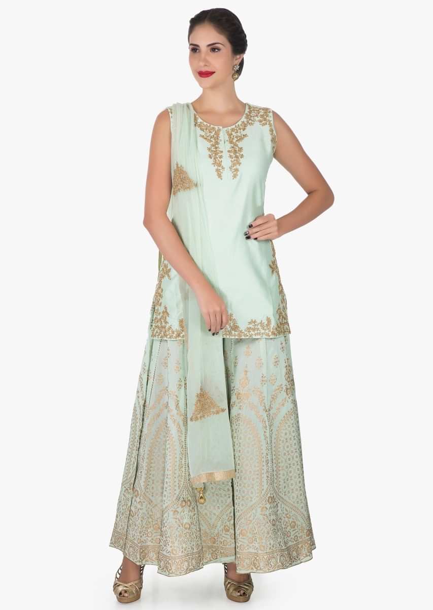 Pista green palazzo suit in silk enhanced in foil print and zari embroidered work only on Kalki
