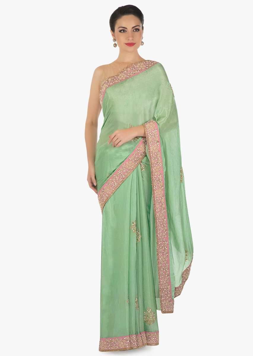 Pista green saree in satin with gotta patch and moti embroidered butti an border only on Kalki