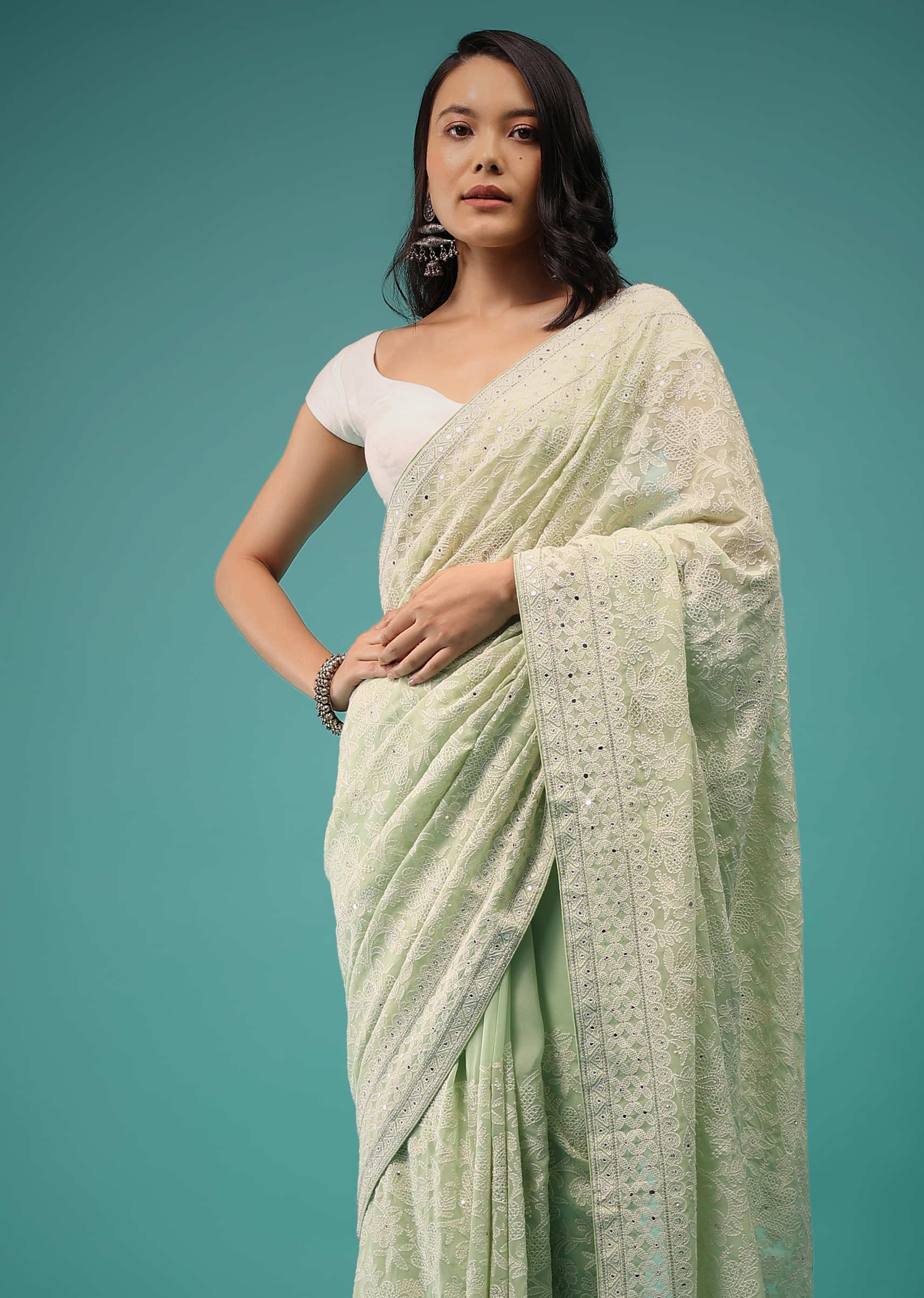 Pistachio Green Georgette Saree In Lucknowi Threadwork, Comes With Mirror Embroidery Detailing On The Border