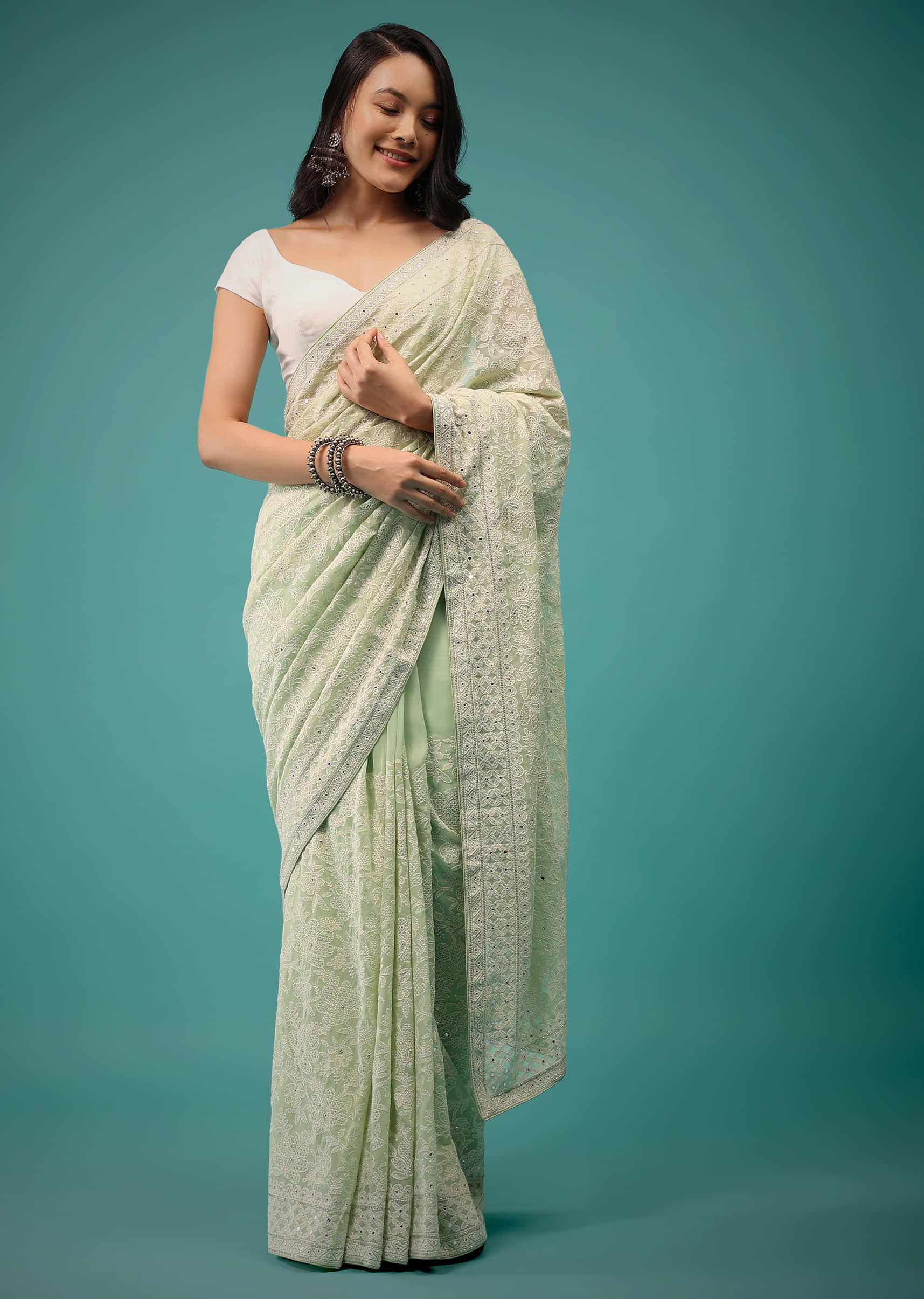 Pistachio Green Georgette Saree In Lucknowi Threadwork, Comes With Mirror Embroidery Detailing On The Border