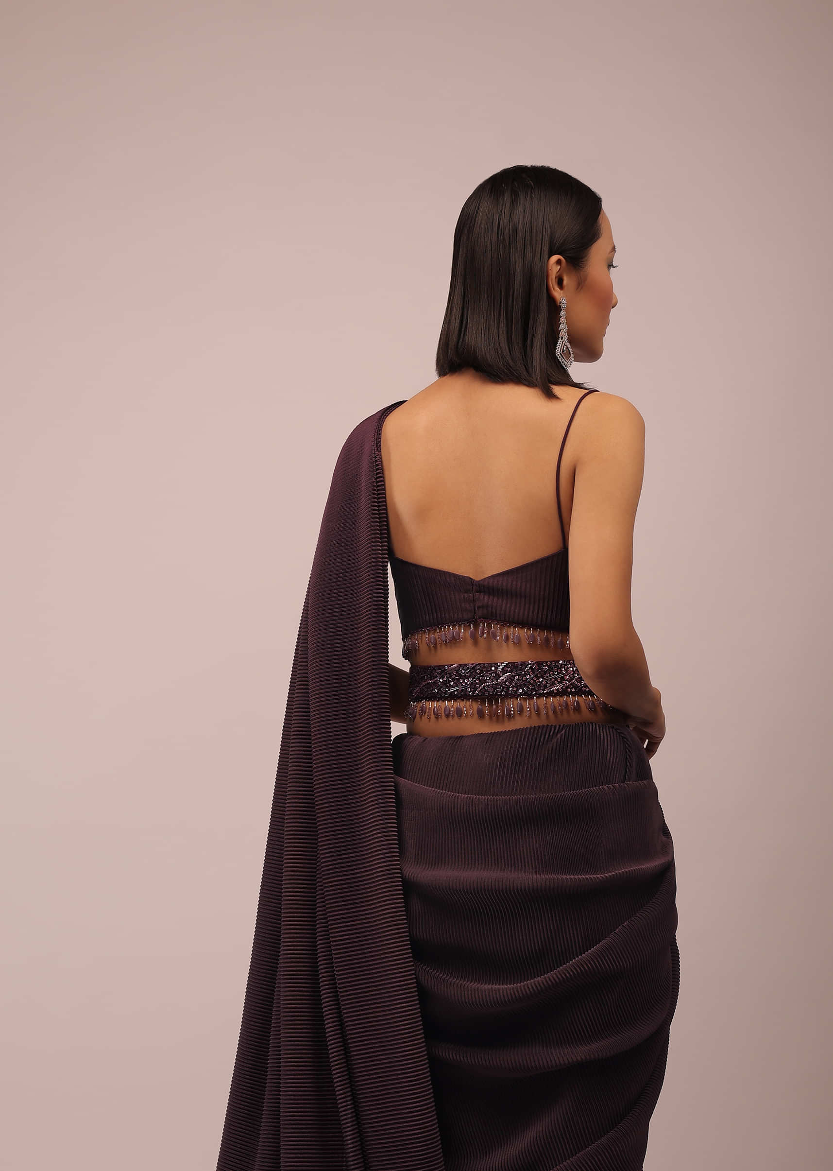 Plum Saree With Moti And Cut Dana Fringes Detailing On The Pallu And A Spaghetti Straps Crop Top With An Embroidered Belt In Fringes
