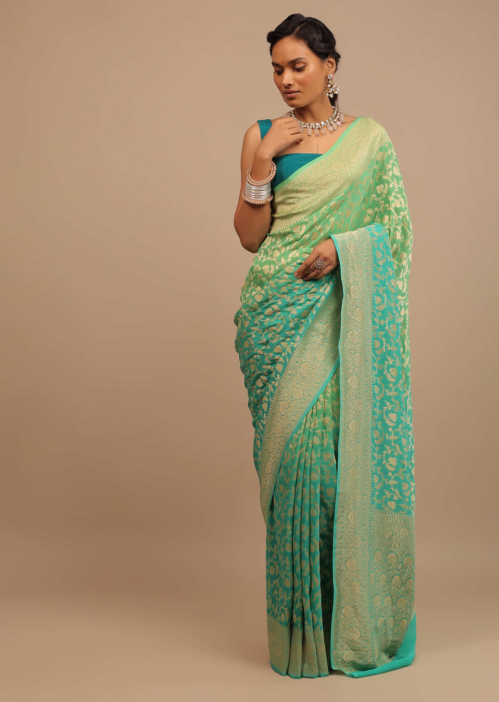 Jade Green Saree Made In Georgette And Beautified With Golden Jaal In A Floral Pattern